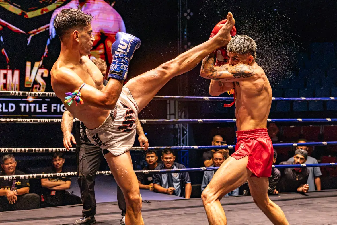 A head kick lands in front of the world title fight screen