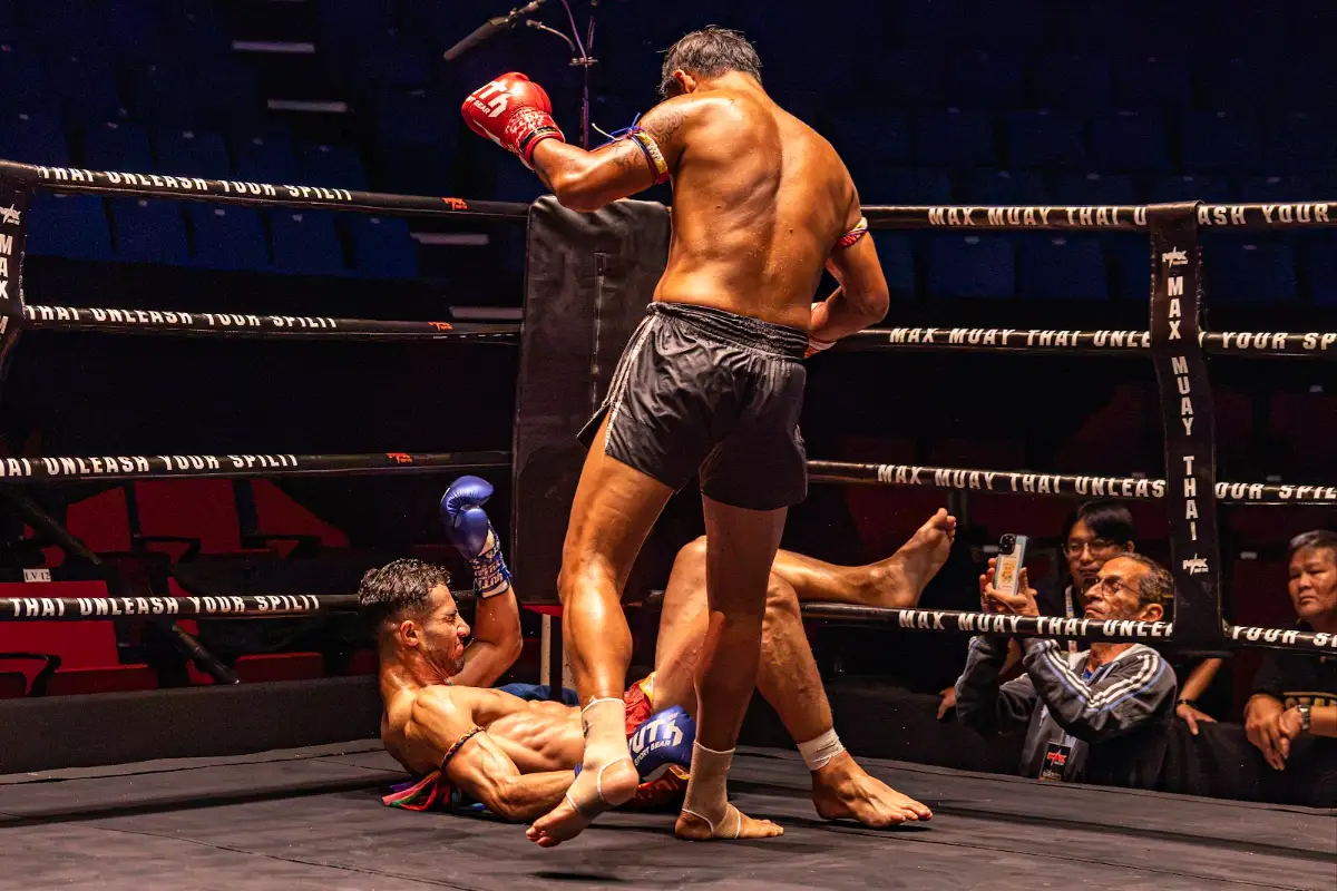 A fighter goes down in the ring at Max Muay Thai Stadium