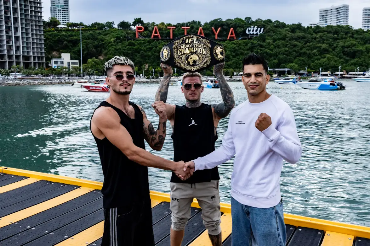 Fighters face off on a pier in front of the Pattaya City sign with the IFL Muay Thai Champion belt